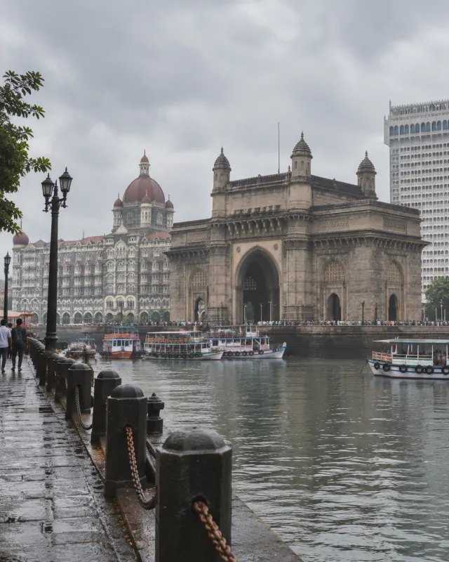 The Gateway of India and ferry boats in Mumbai harbour on an overcast morning